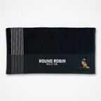 Black golf towel with white stripes and 'Round Robin Golf Co.' logo on a white background