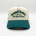 Beige and teal cap with 'Round Robin Golf Co. Find Your Fairway' text on a white background