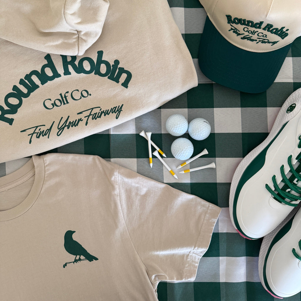 Golf-themed clothing and accessories on a checkered tablecloth