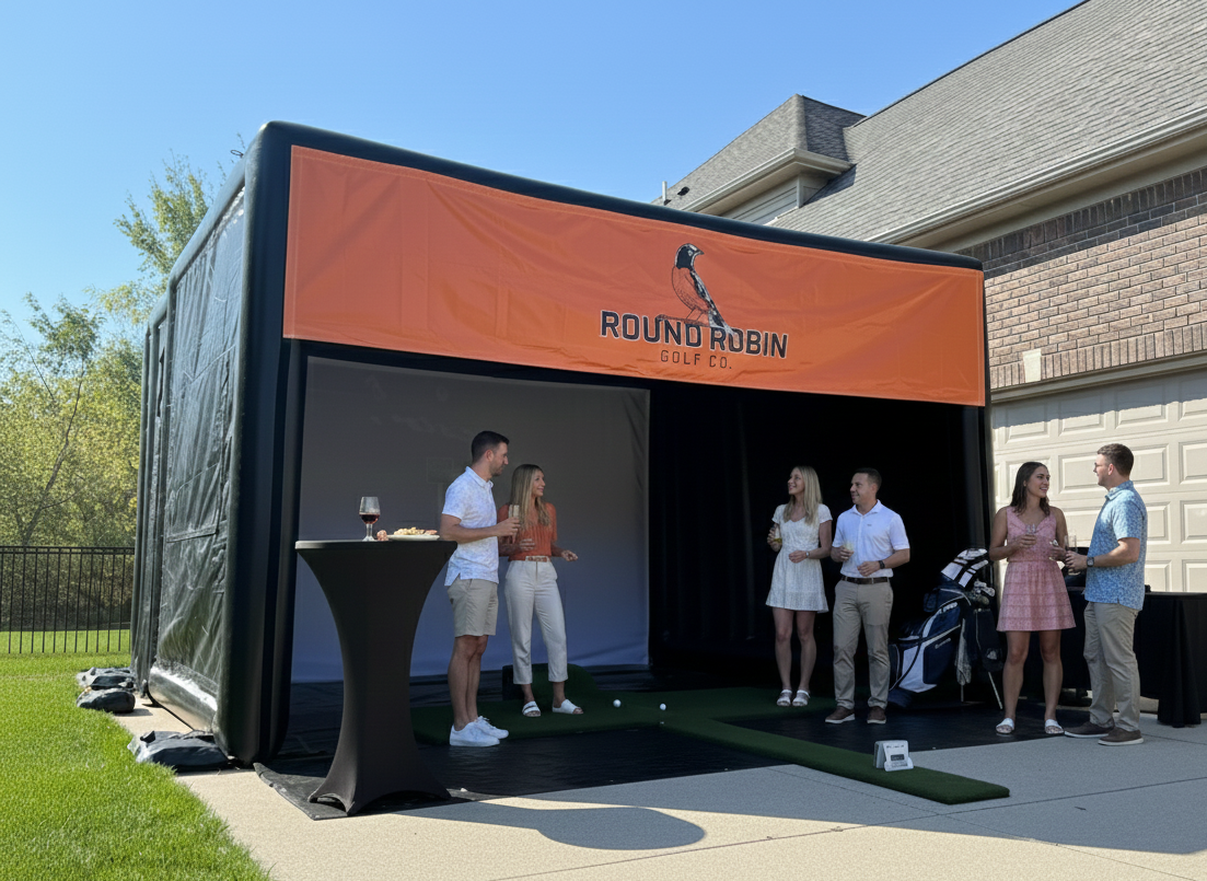 People at a party, outside a home. Playing golf in a mobile golf simulator. 
