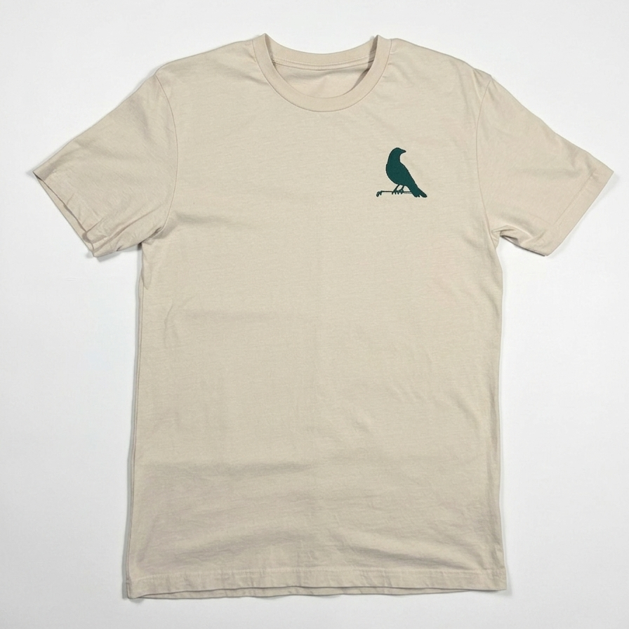 Beige t-shirt with a green bird graphic on a white background