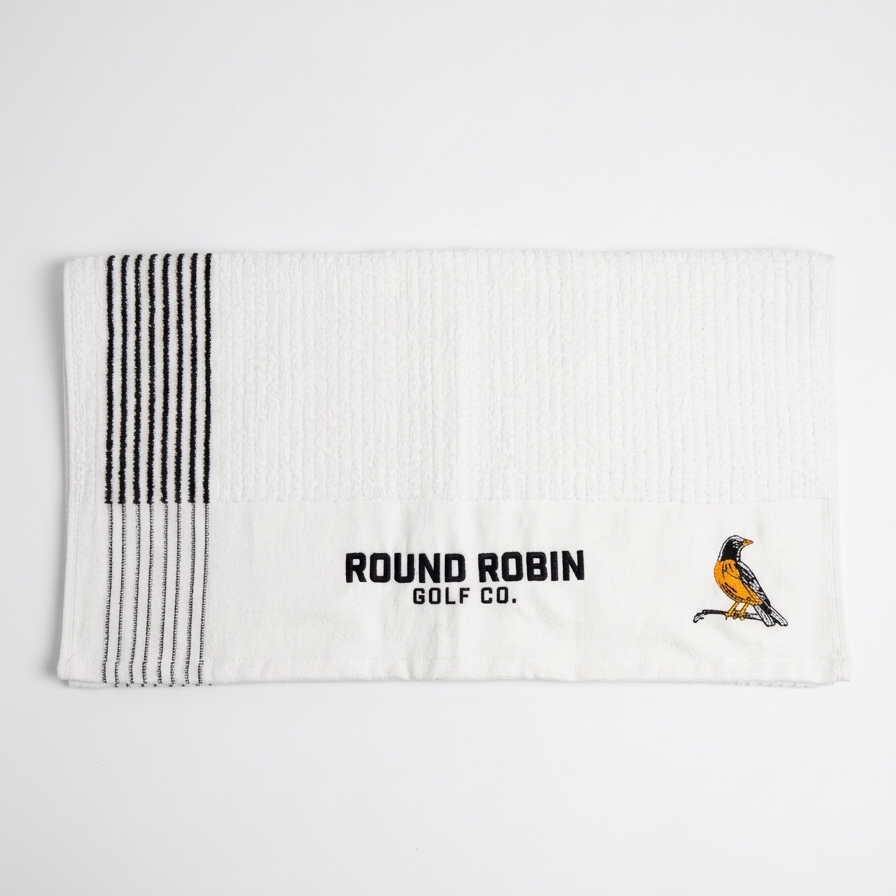 White golf towel with black stripes and 'Round Robin Golf Co.' logo on a white background